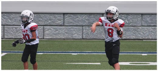 A football player catching a ball. Description generated by AI