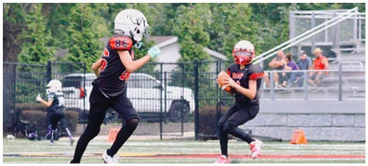 A football player catching a ball. Description generated by AI