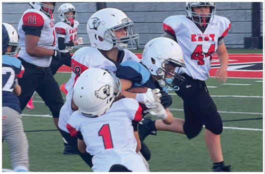 A football player catching a ball. Description generated by AI