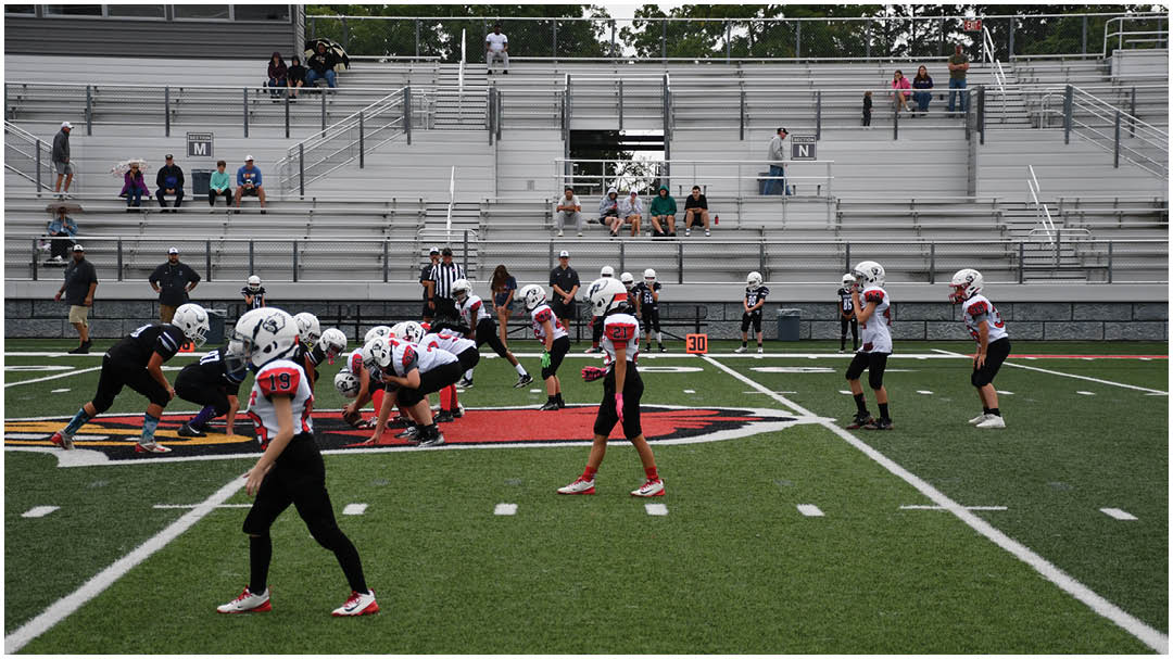 A football game is being played on a field. Description generated by AI