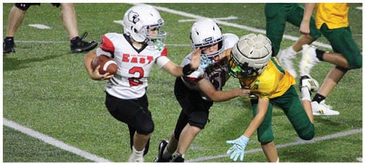 A football player catching a ball. Description generated by AI