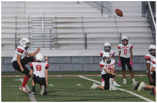 A football player catching a ball. Description generated by AI
