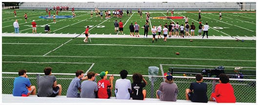 A football player catching a ball. Description generated by AI