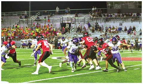 A football player running on the field. Description generated by AI