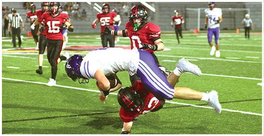 A football player running on the field. Description generated by AI