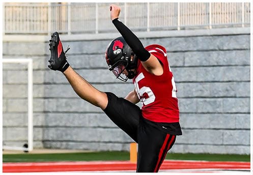 A football player running on the field. Description generated by AI