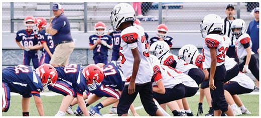 A football player catching a ball. Description generated by AI