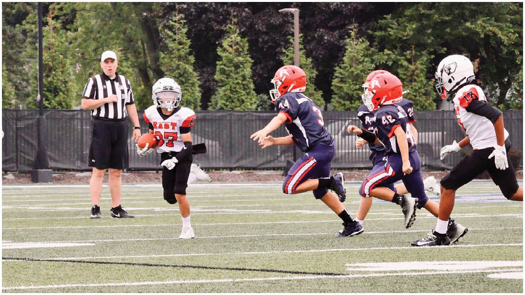 A football game is being played on a field. Description generated by AI