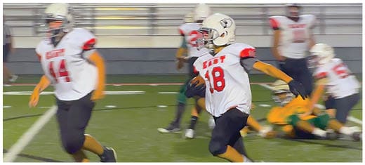 A football player catching a ball. Description generated by AI