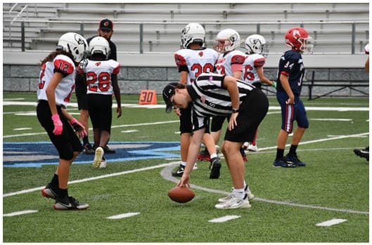 A football player catching a ball. Description generated by AI