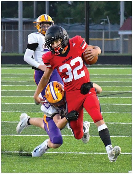 A football player running on the field. Description generated by AI