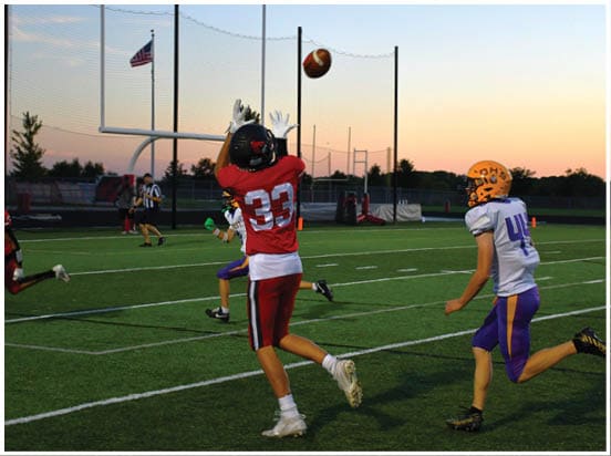 A football player wearing a blue jersey with the number 58 on it. Description generated by AI