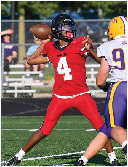 A football player running on the field. Description generated by AI