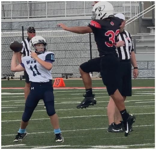 A football player catching a ball. Description generated by AI
