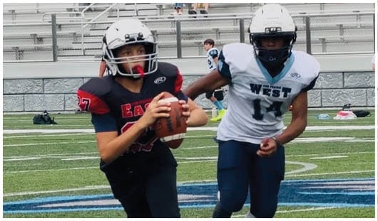 A football player catching a ball. Description generated by AI