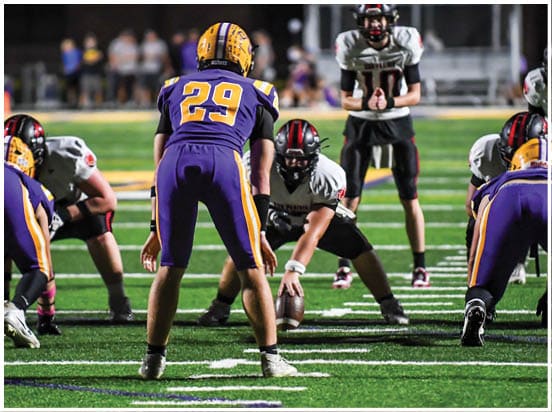 A football player wearing a blue jersey with the number 58 on it. Description generated by AI