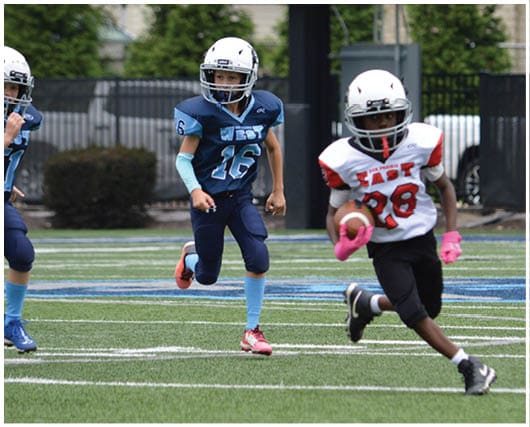 A football player catching a ball. Description generated by AI