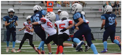 A football player catching a ball. Description generated by AI