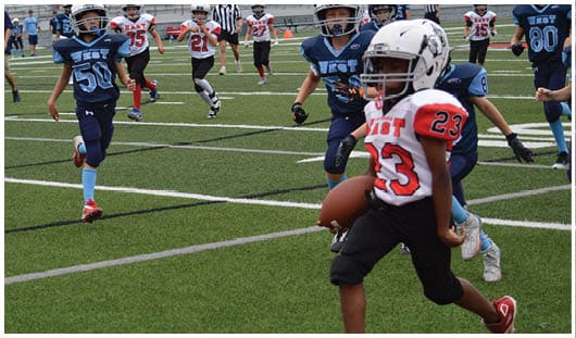 A football player catching a ball. Description generated by AI