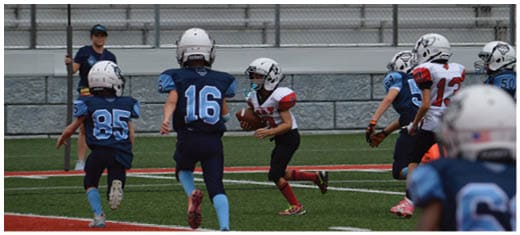 A football player catching a ball. Description generated by AI