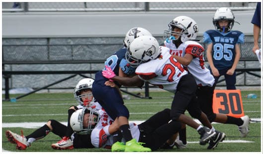 A football player catching a ball. Description generated by AI