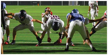 A football player wearing a blue jersey with the number 58 on it. Description generated by AI
