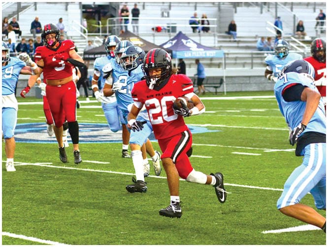 A football player catching a ball. Description generated by AI