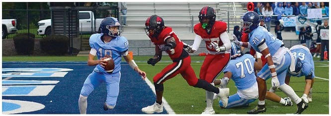 A football player catching a ball. Description generated by AI