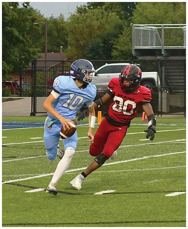 A football player catching a ball. Description generated by AI