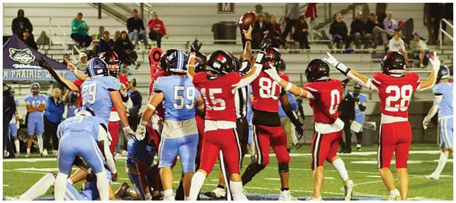 A football player catching a ball. Description generated by AI