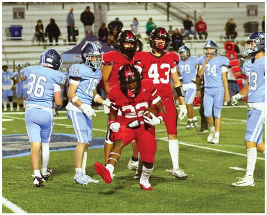 A football player catching a ball. Description generated by AI
