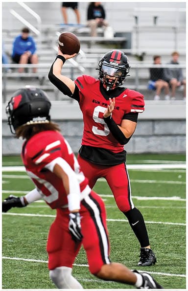 A football player catching a ball. Description generated by AI