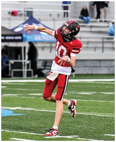A football player catching a ball. Description generated by AI
