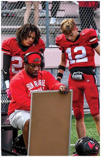 A football player catching a ball. Description generated by AI