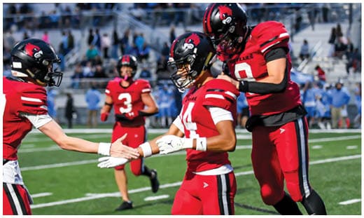 A football player catching a ball. Description generated by AI