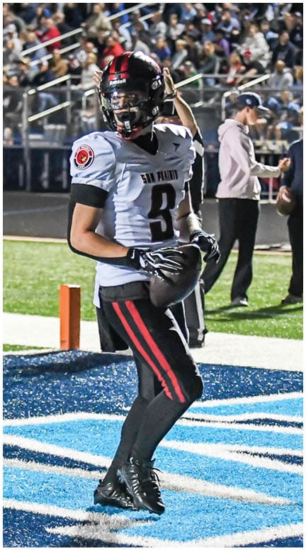 A football player running on the field. Description generated by AI