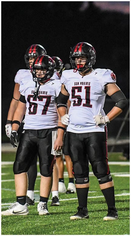 A football player running on the field. Description generated by AI
