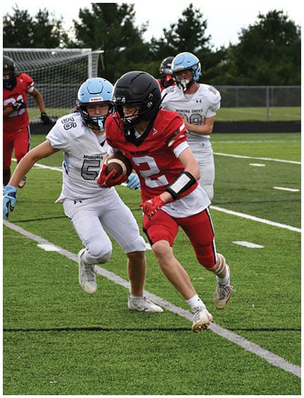 A football player running on the field. Description generated by AI