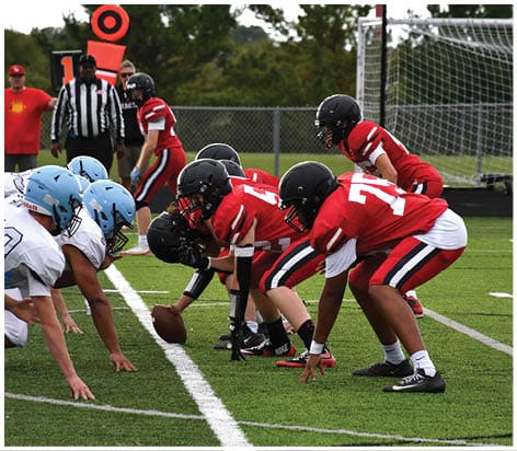 A football player wearing a blue jersey with the number 58 on it. Description generated by AI