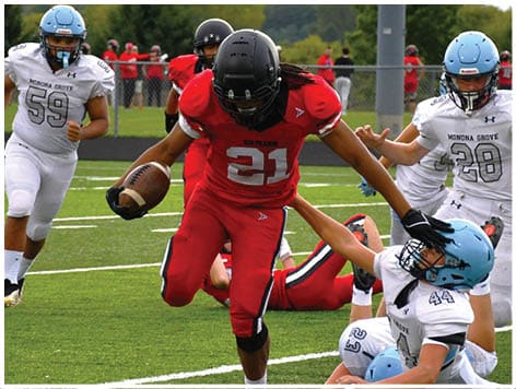 A football player wearing a blue jersey with the number 58 on it. Description generated by AI