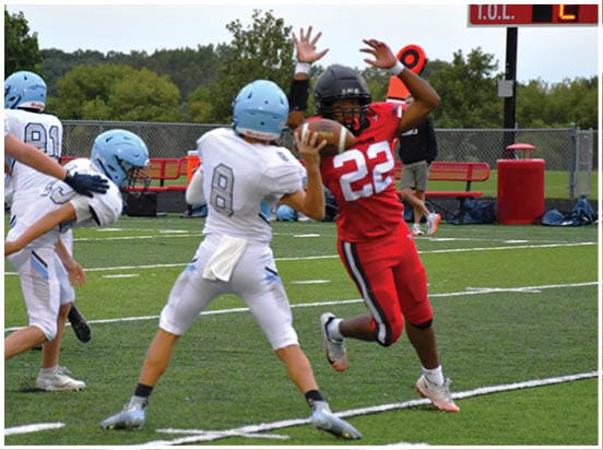 A football player wearing a blue jersey with the number 58 on it. Description generated by AI