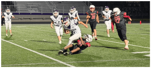 A football player catching a ball. Description generated by AI