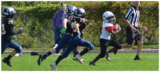 A football player catching a ball. Description generated by AI