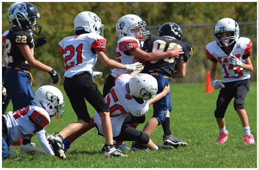 A football player catching a ball. Description generated by AI