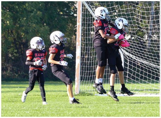 A football player catching a ball. Description generated by AI
