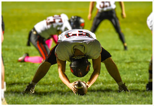 A football player running on the field. Description generated by AI