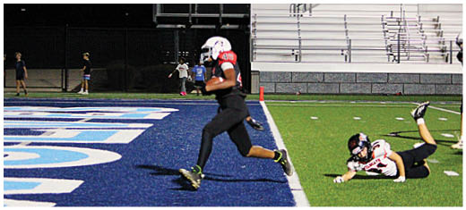 A football player catching a ball. Description generated by AI