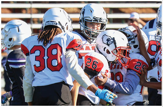 A football player catching a ball. Description generated by AI