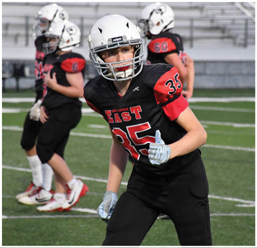 A football player catching a ball. Description generated by AI