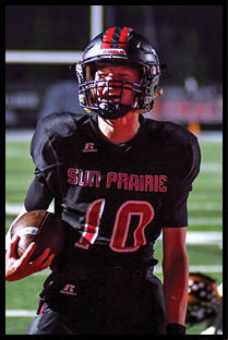 A football player running on the field. Description generated by AI